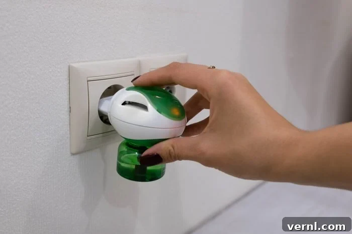 Best Indoor Mosquito Traps: Eliminate Pests and Enjoy Your Home 2 Electric mosquito trap device. insect killer. A woman puts a raptor from an insect into an electrical outlet