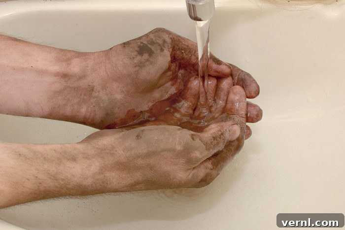 Man Washes Dirty Hands After Working Outdoors