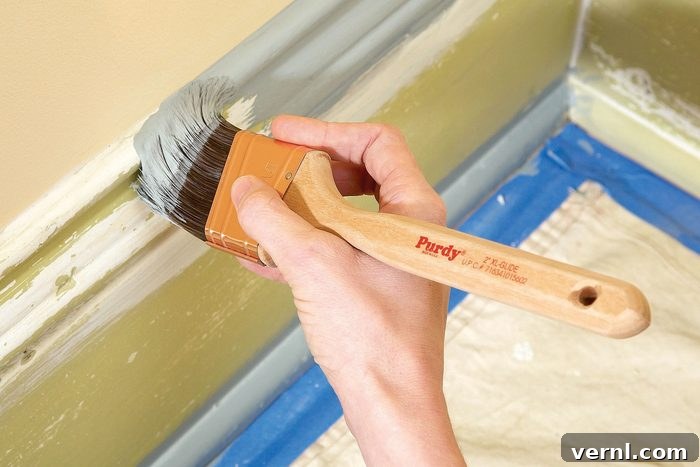 11 Professional Secrets for Perfect Trim Painting 6 A peron painting edges of the wall