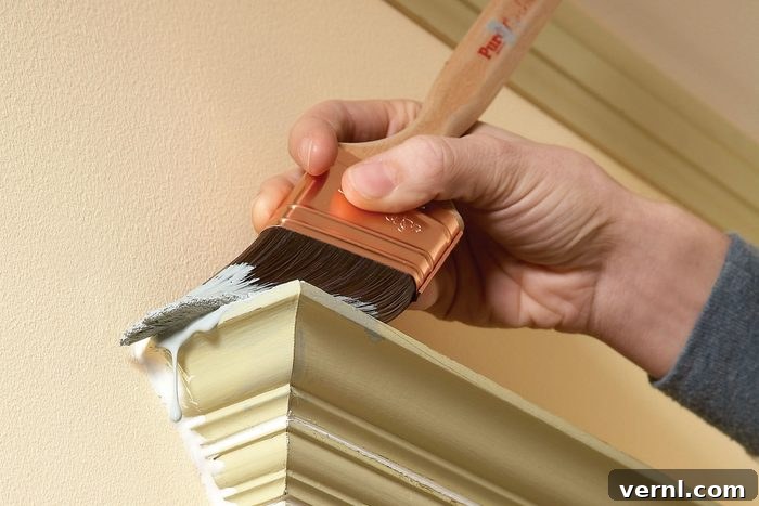 11 Professional Secrets for Perfect Trim Painting 8 A person paints a the edges of a wall with a brush