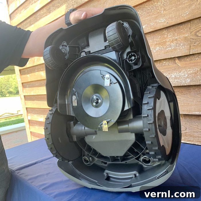 Husqvarna Automower robotic lawn mower in action on a lush green lawn