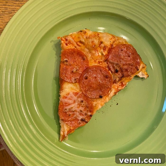 Solo Stove Pi Fire Review: The Ultimate Fire Pit Pizza Upgrade 7 pizza slice on a green plate made with the Solo Stove Pi Fire