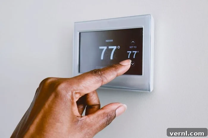 Close-up of unrecognizable black woman adjusting thermostat