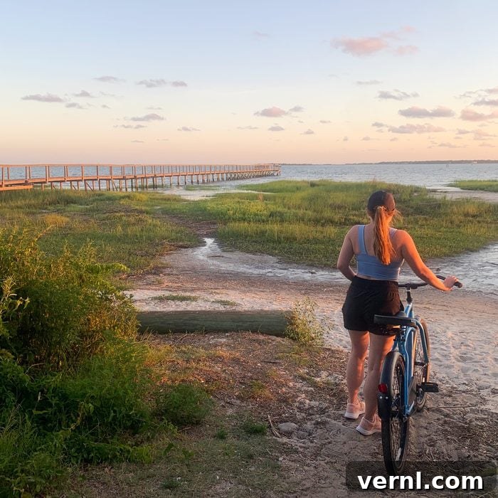 Woman riding a bike into the sunset wearing Breeze Shorts Free Fly
