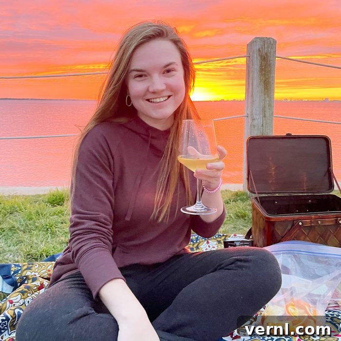 Woman wearing a Bamboo Fleece Jogger while drinking wine at sunset