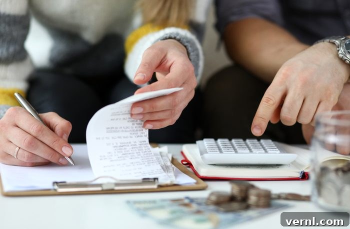 HELOC Versus Home Equity Loan Choosing the Best Option 3 Close-up view of man and woman making account of family income by Writing down and calculating expenses