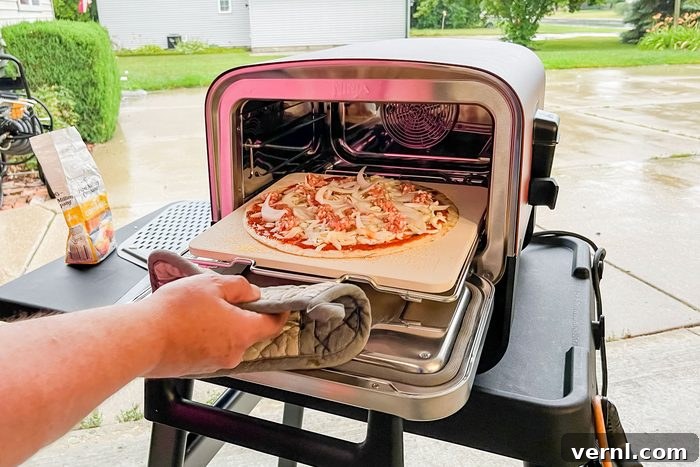 Is the Ninja Woodfire 8-in-1 Outdoor Oven a Game Changer? Our Test Results 6 Putting Pizza into Ninja Woodfire Outdoor Oven