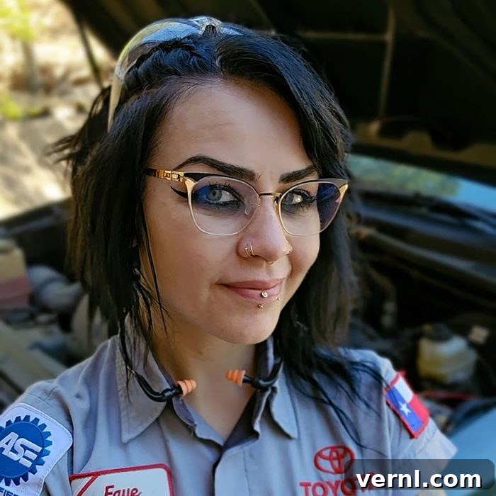 Portrait of Faye Hadley, a mechanic with a confident smile, surrounded by tools and a vehicle, embodying expertise and approachability.