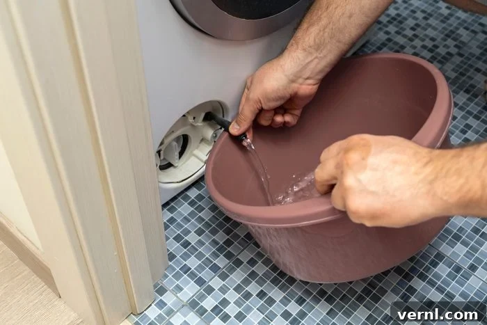 Decoding Your Washer's Nasty Smell 3 the filter of the washing machine is clogged. Plumber repairs washing machine.