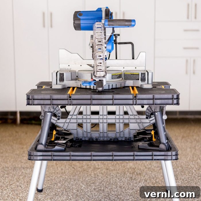 Keter Folding Work Table: A Professional Woodworker's Shop Floor Test 4 Reviewer actively using the Keter Folding Work Table, securing wood for a project with the integrated clamps.