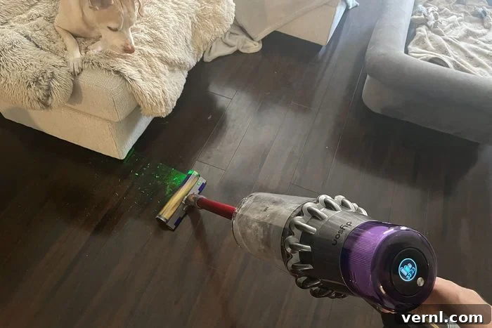 Dyson Outsize Plus vacuum cleaning a wooden floor, highlighting its efficiency