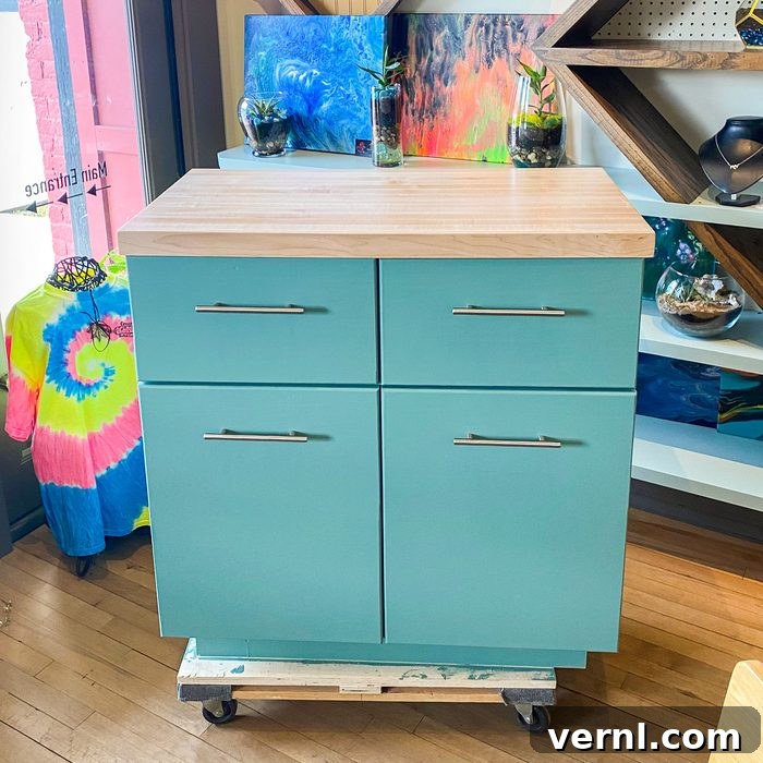 The Eleven Percent: Tonda Thompson, Building Blocks of Wood and Community 3 A stylish turquoise kitchen storage cabinet displayed in a retail store