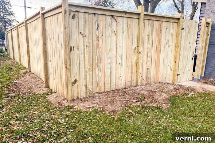 The Eleven Percent: Tonda Thompson, Building Blocks of Wood and Community 4 A meticulously crafted wooden privacy fence standing tall amidst lush green grass