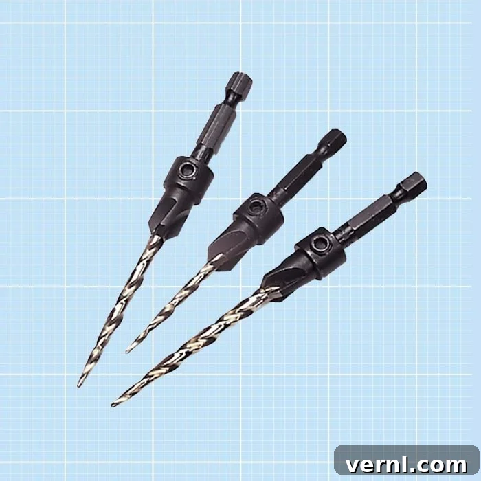 Three countersink drill bits on a blue grid background