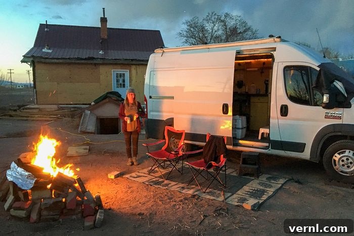 The Unspoken Realities of Buying a Fixer-Upper 3 A woman next to a campfire in front of a white van.