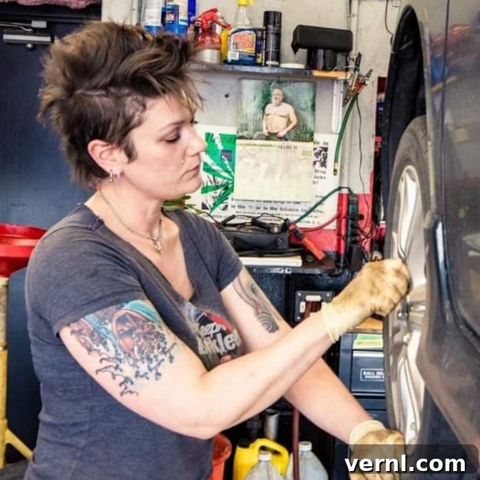 Valerie Adams: The Engine of Change 2 A women working on a broken car