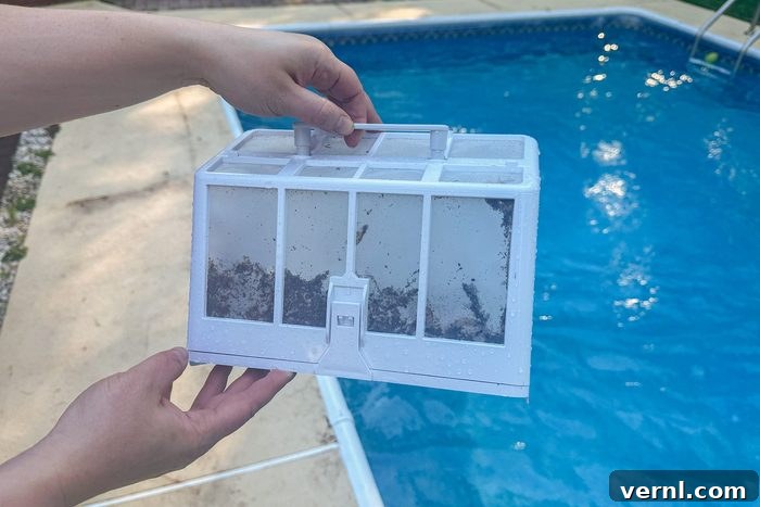 Wybot Pool Cleaner Review My New Favorite Chore 8 Person holding Wybot C1 Robotic Pool Cleaner filled up filter