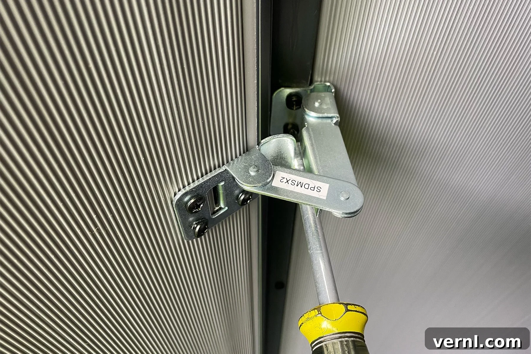 Keter Storage Shed Review: Smart Storage for Small Outdoor Spaces 5 Screwing the hinges of Keter Shed