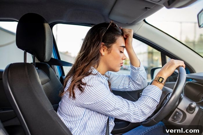 The Perils of Neglecting Your Vehicle's Recall 2 Stressed woman in a driver's seat of a car