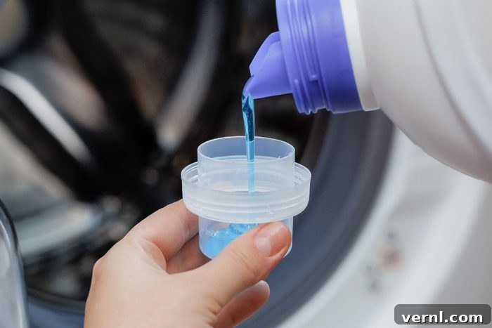 Liquid detergent being pouring into a washing machine dispenser