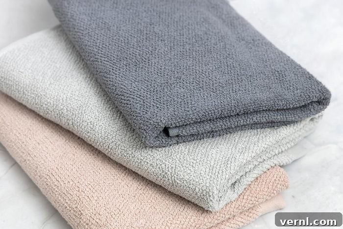 Here's Why Your Towel Has a Strip 2 Folded clean towels on white marble background
