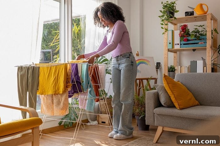 The Drying Showdown: Is Air Drying or Machine Drying Best for Your Clothes and Budget? 2 Smiling young woman drying clothes on rack by sofa in living room