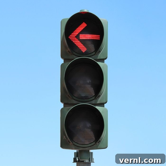 Traffic light isolated in the sky with Red arrow light on.