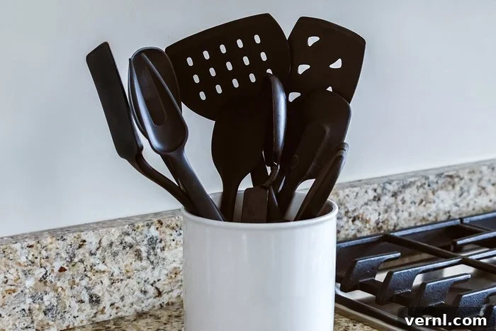 Why Your Black Plastic Utensils Need to Go 2 Close-up view of black plastic cooking utensils in container on kitchen counter, highlighting the commonality of the material.