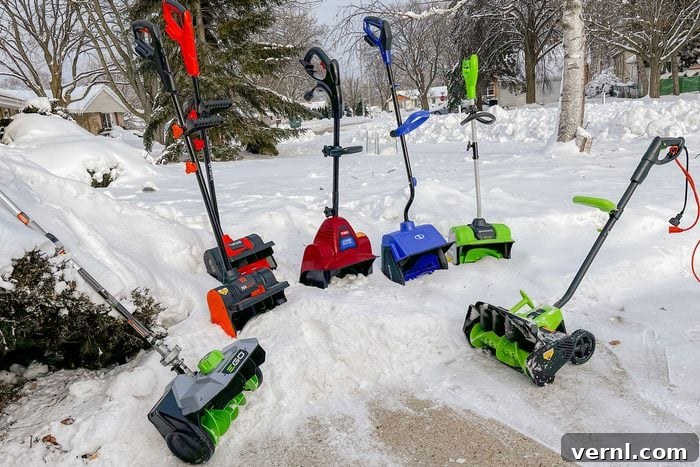 Two electric snow shovels, Greenworks and EGO, positioned side-by-side for comparison.