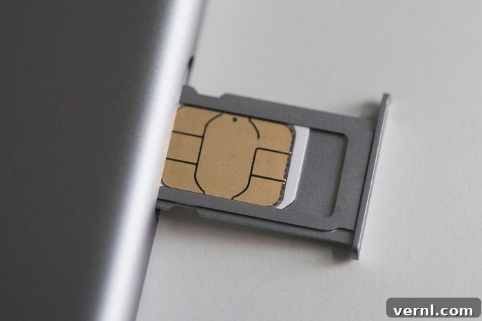 Unlocking the Secrets of Your Phone's Side Holes 2 Close-up of sim card and mobile phone on white table