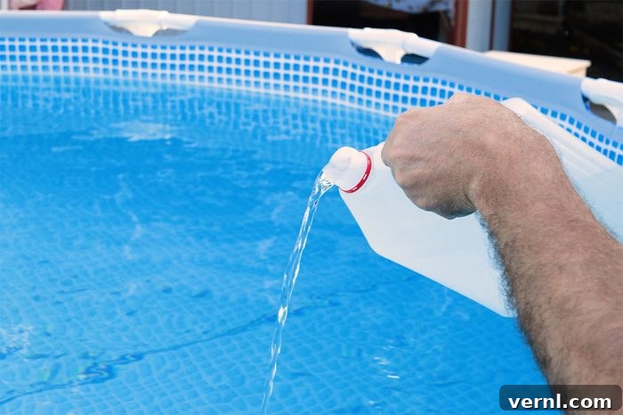 Hand adding specialized winterizing chemicals to an above-ground pool before covering for winter.
