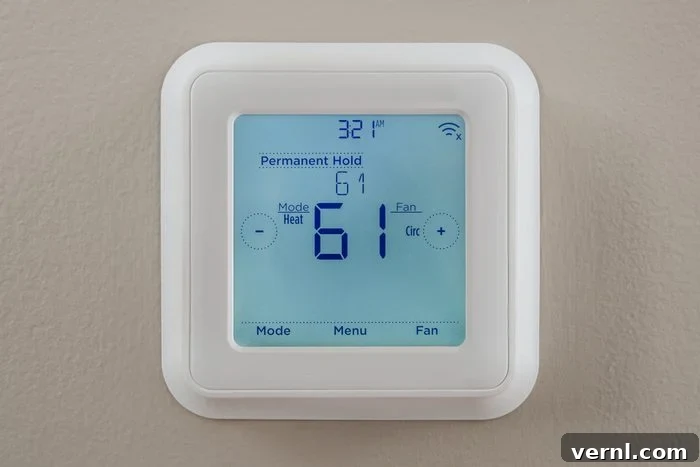 Holiday Energy Hacks for a Cheaper Season 2 modern residential programmable heating and cooling thermostat mounted on a wall