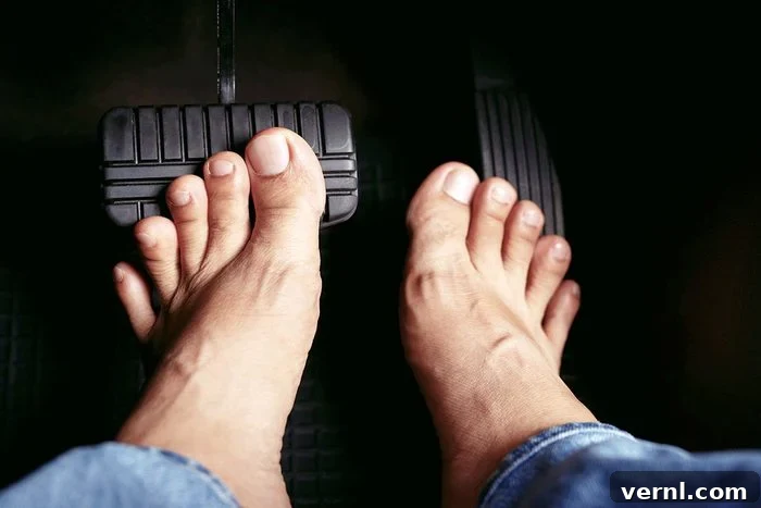 Barefoot Behind the Wheel: Understanding Driving Footwear Laws 2 Is All Footwear Legal For Driving Gettyimages 1385618593
