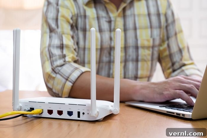 Wifi Router next to man using laptop