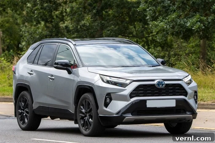 Top Cars of 2025: A Year of Triumphs 6 TOYOTA RAV4 car driving on an English roa