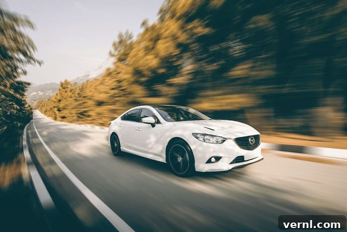 Car Mazda driving on road at daytime