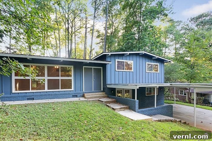 The exterior of the home after being flipped by previous owners, featuring a blue and white color scheme.
