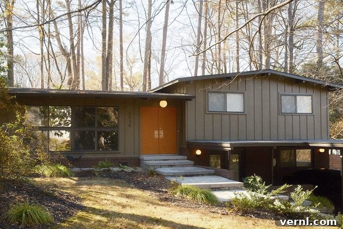 The exterior of Dana and Colin's home after restoration, showcasing a period-accurate color and design.