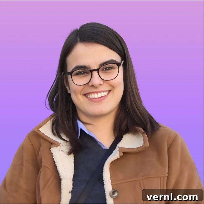 Family Handyman's Women Share Their DIY Insights 5 A person with straight dark hair, wearing glasses and a brown jacket with a light shearling collar, smiles in front of a purple gradient background. Their expression is friendly and direct.