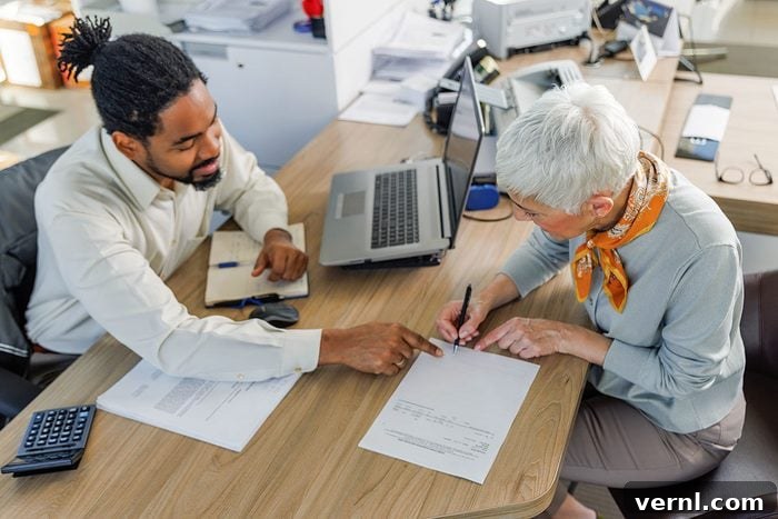 This One Dealer Trick Costs You Thousands on Your Car Loan 2 Senior woman signing document with salesperson at desk
