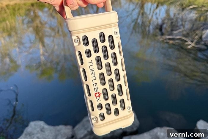The Unbreakable Sound: Our Deep Dive into the Turtlebox Speaker 6 Turtlebox Ranger being held in front of a body of water