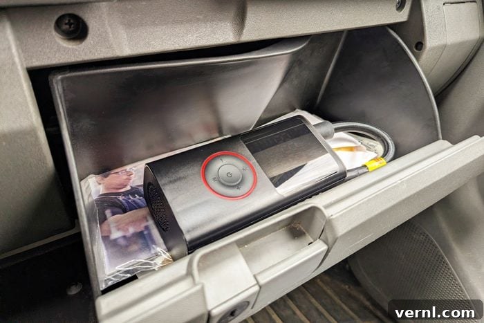 Portable Tire Inflator Speed Test: Real-World Fill Times 4 Powools Portable Tire Inflator fitting into a car's glove box, demonstrating ultimate portability.