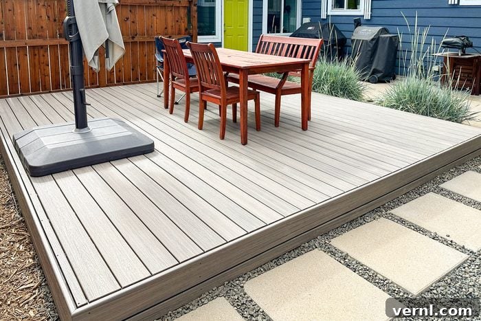 Father and Son Build a Stunning Deck in Just One Week 4 chairs and a table on finished deck in backyard