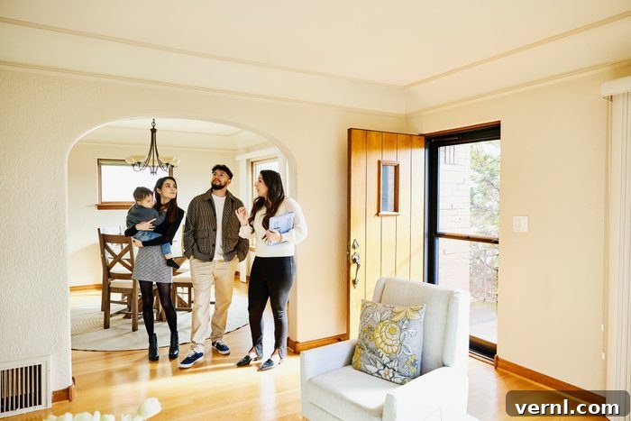 Key Questions to Ask a Realtor Before You Hire Them 2 Wide shot of family looking at home for sale with real estate agent