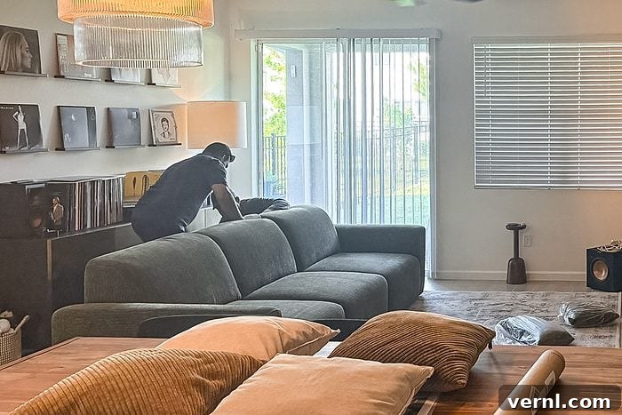 delivery team member setting up Povison Aurora Power Sleeper Sofa in the living room