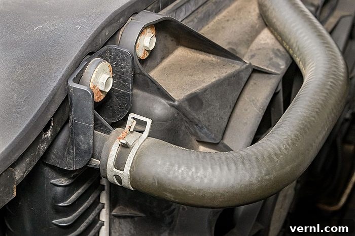 How a Hot Garage Can Secretly Damage Your Car 2 Cooling system radiator hose on car engine.