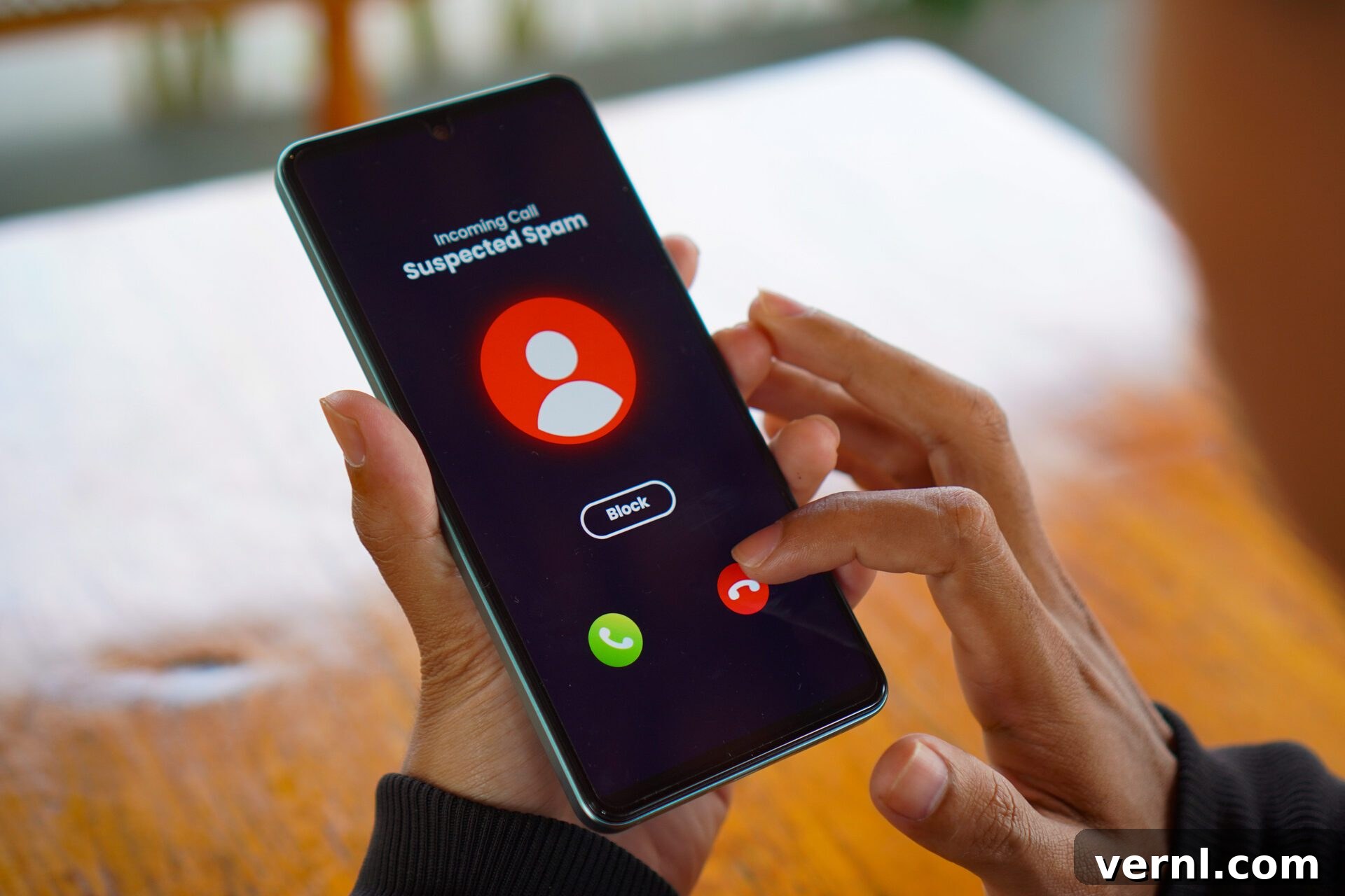Protect Your Real Phone Number From Spam Callers 2 Man receiving an incoming suspected call from unknown caller on her smartphone and rejecting the call