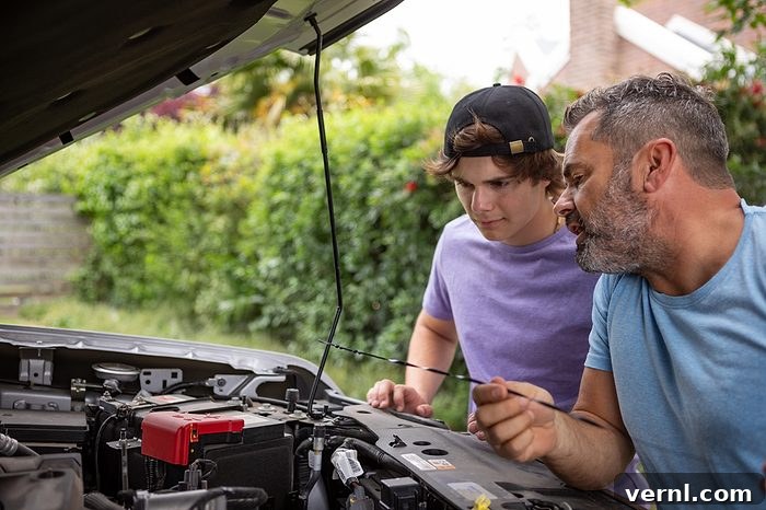 How Car Maintenance Has Evolved Over the Decades 2 Father teaching his teenage son how to repair a car