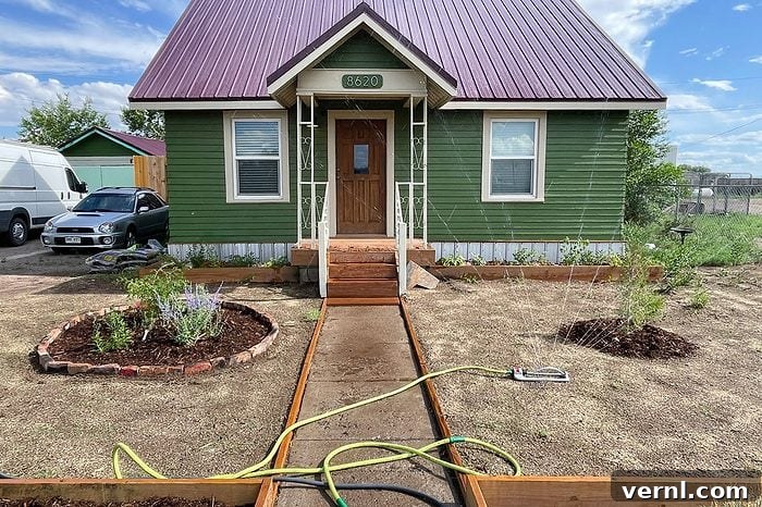 What Happened When I Replaced My Lawn With a Wildflower Meadow 3 sprinkler watering the front yard of house