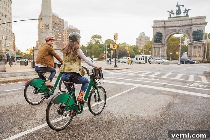 Couple riding bicycle on city street